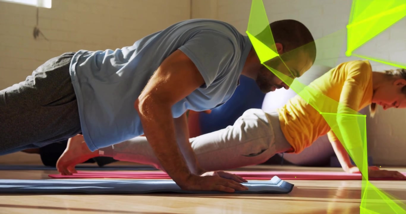 After start signal, man and woman moving from plank into push-ups building core strength in fitness