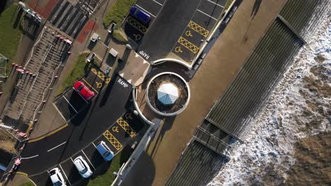 Slow-motion-drone-rise-up-at-seaside-with-waves-crashing-in-winter-at-Cleveleys