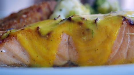 grilled salmon with yellow sauce and vegetables