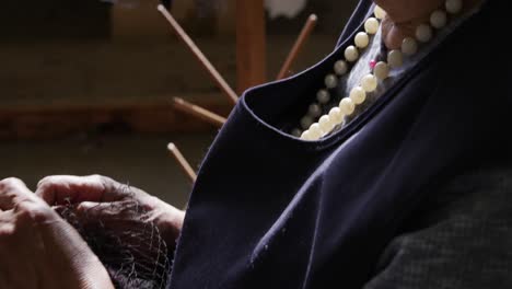 mixed race woman working at a hat factory