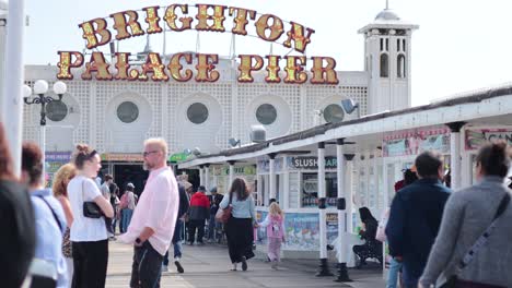 people walking and interacting at brighton palace pier