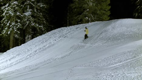 a snow boarder performs a stunt on a metal cylinder