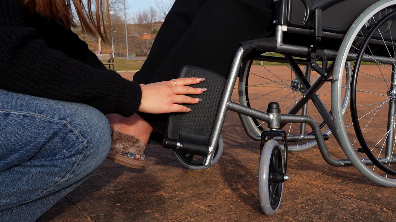 Grandmother in a wheelchair prepares for a walk in the park