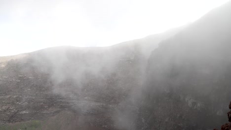 heavy mist seen inside inside rim crater wall at mount vesuvius