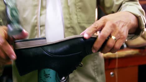 cobbler hammering on shoe sole