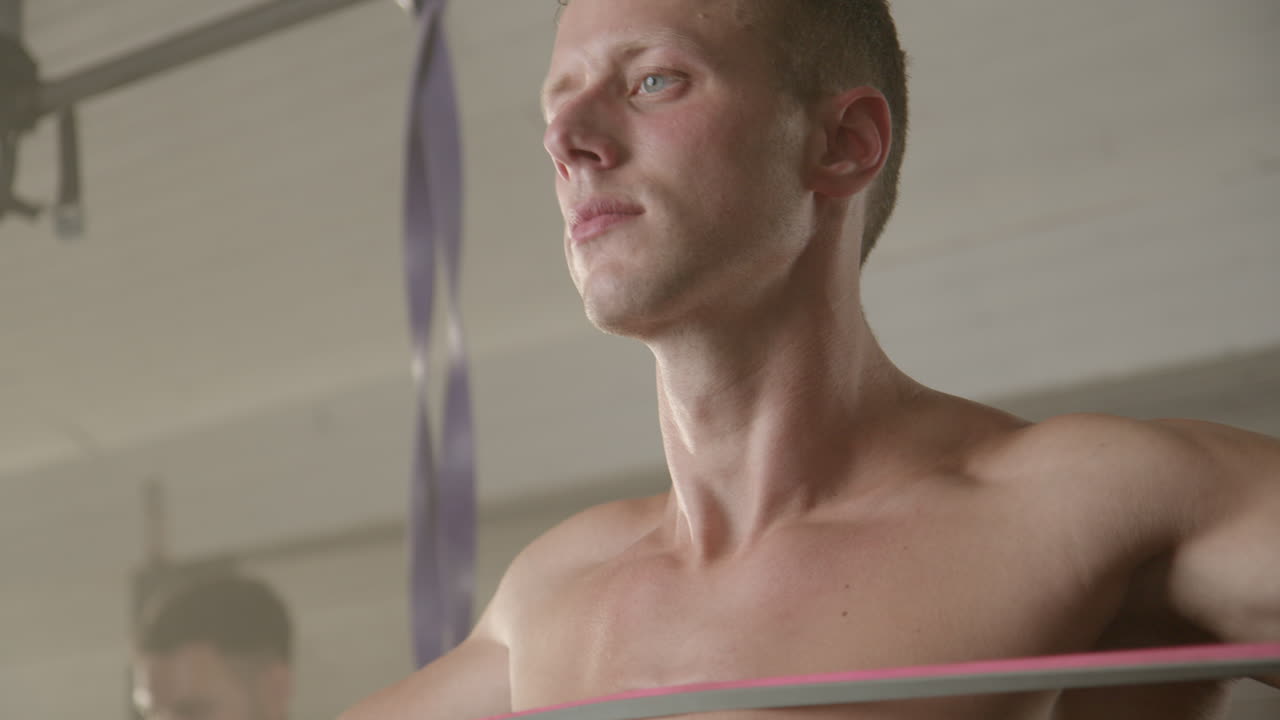 Man exercising with resistance band in gym