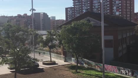 Barcelona-panning-view-of-Sants-neighborhood-over-little-tree-park-and-avenue-buildings