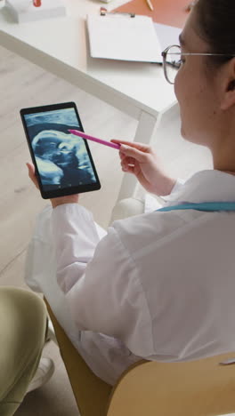 doctor showing ultrasound image to patient