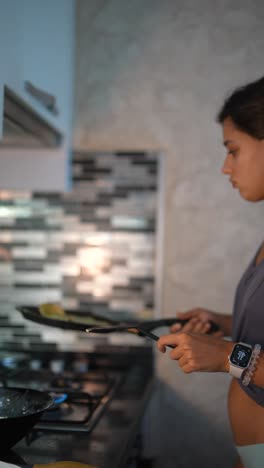 woman cooking pancakes in kitchen