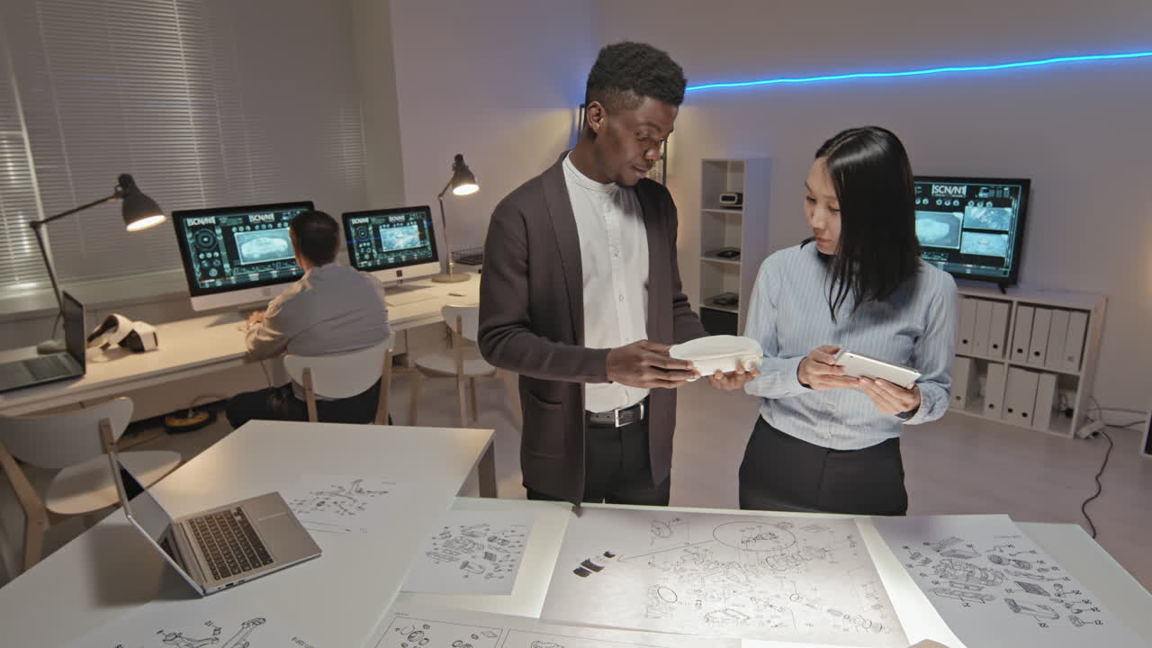 Engineer Discussing 3D Printed Car Model with Colleague