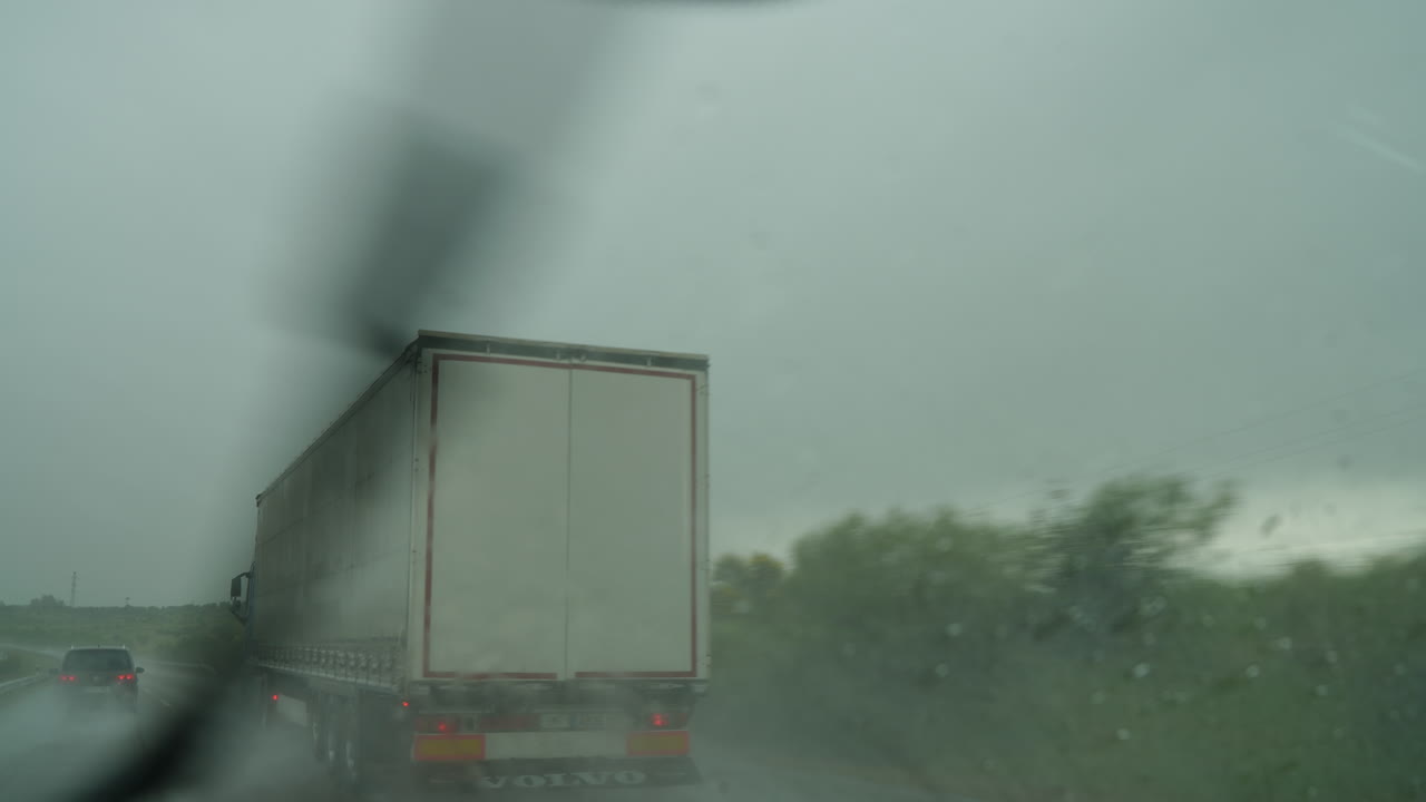 Truck driving on highway during heavy rain