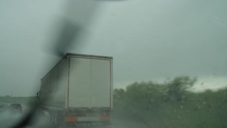 truck driving on highway during heavy rain