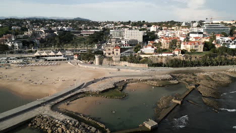 wide drone shot zooming out of coastline castle in lisbon, portugal