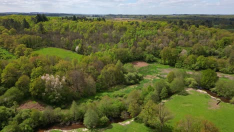 flying over green meadows and glane river in france