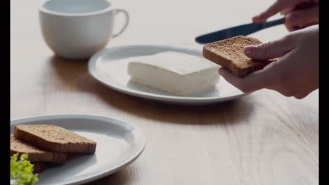 preparing toast with butter