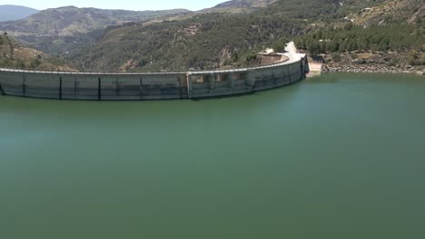 vault dam. dam spillway. reservoir. aerial view of road over curved dam. spain.