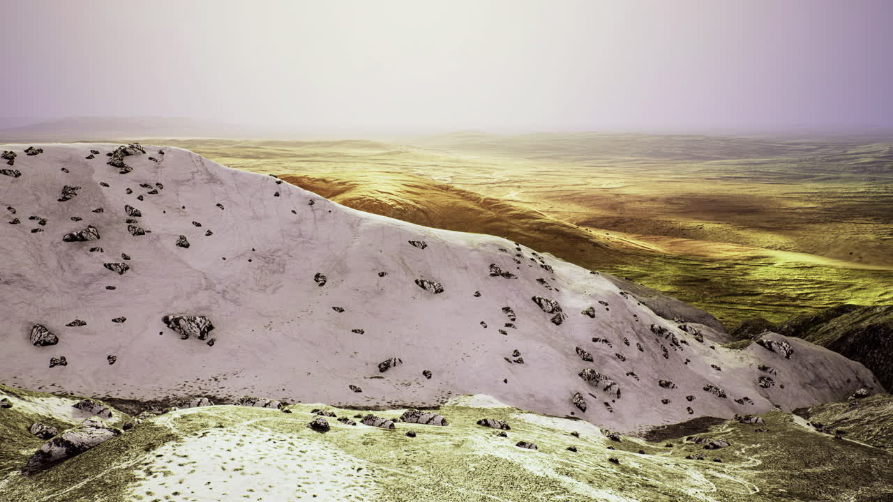 Expansive landscape of rolling hills and rocky terrain at dusk