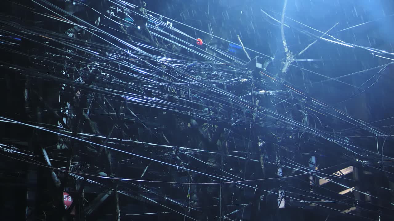 Rain pours over chaotic cables and dim street lights Metro Manila Philippines