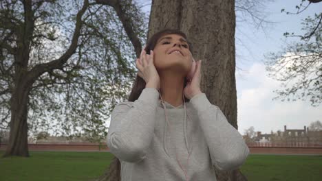 Caucasian-female-listening-to-music-through-her-headphones