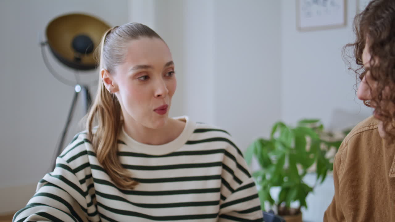 Boyfriend feeding girlfriends grape in kitchen closeup. Husband giving fruits