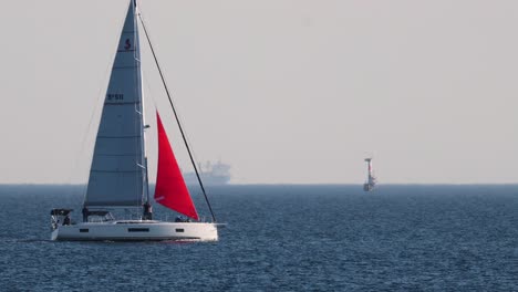 sailboat cruising on calm ocean near brighton beach