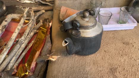 pan shot of tea being prepared in old aluminium kettle in local dhaba in bihari style