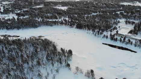 Snow Covered Coniferous Forest In Lapland, Finland - aerial drone shot