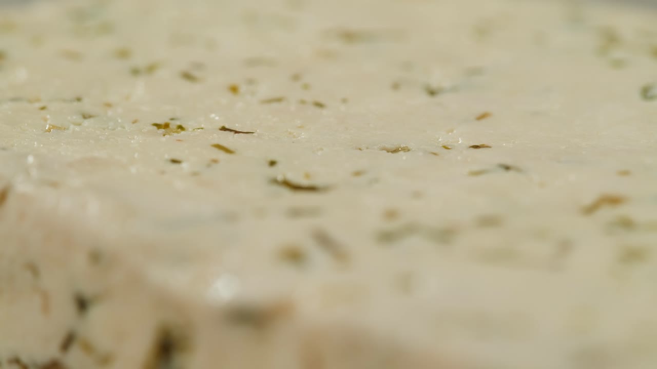 Fried tofu with sesame seeds and spices on cast iron pan, cooking japanese salad. Healthy ingredient for cooking vegan vegetarian diet food. Roasted tofu over black background.