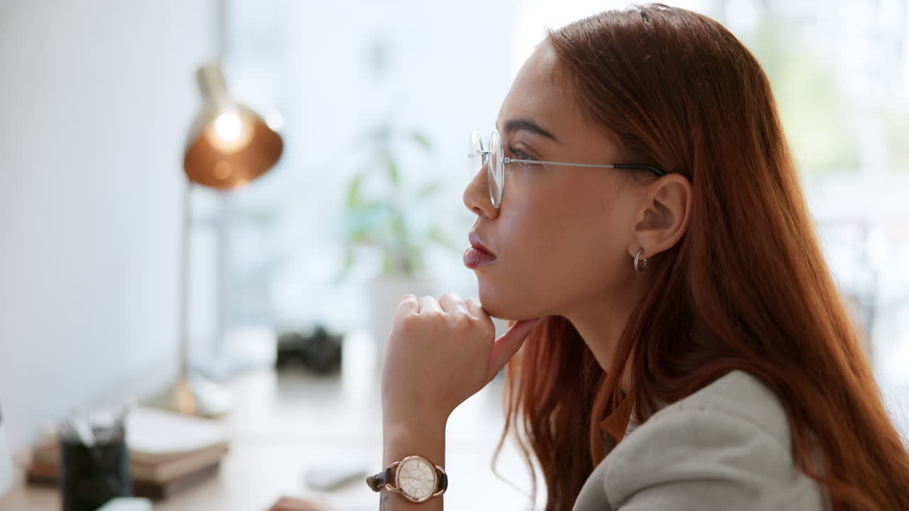 Woman in glasses at desk