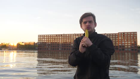 Video-of-a-man-pretending-to-shoot-a-banana-like-a-gun-on-a-pier