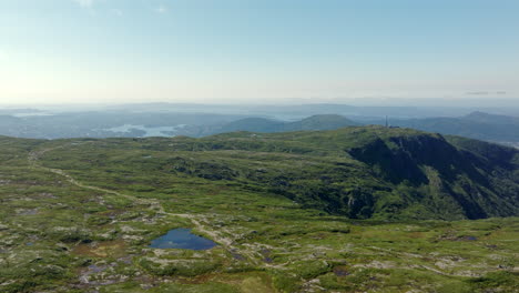 sweeping aerial panorama of vidden plateau with bergen city and fjords in the distance