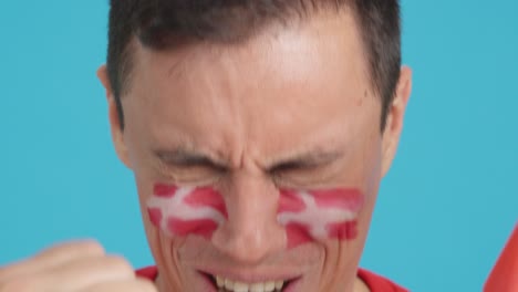 close up of a man supporting danish team