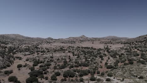 4k drone shot of alhama de granada, spain, filmed with a dji at 30fps. a cinematic aerial view of an empty arid prairie, showcasing the vast semi-desert landscape and rugged terrain.