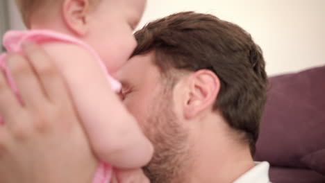 father kissing daughter at home. happy father day. dad kiss baby