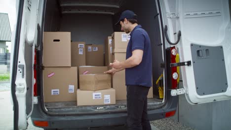 tracking video of courier checking packages in the trunk