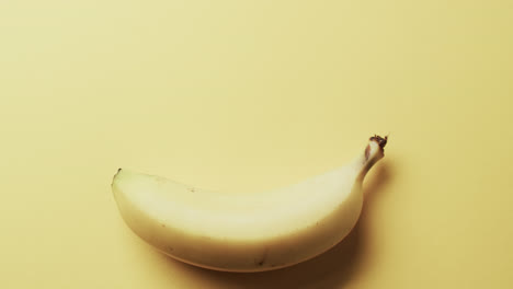 video of banana with copy space over yellow background