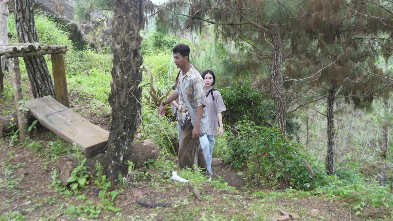 Young Asian Friends Walking on Forest Footpath in Nature