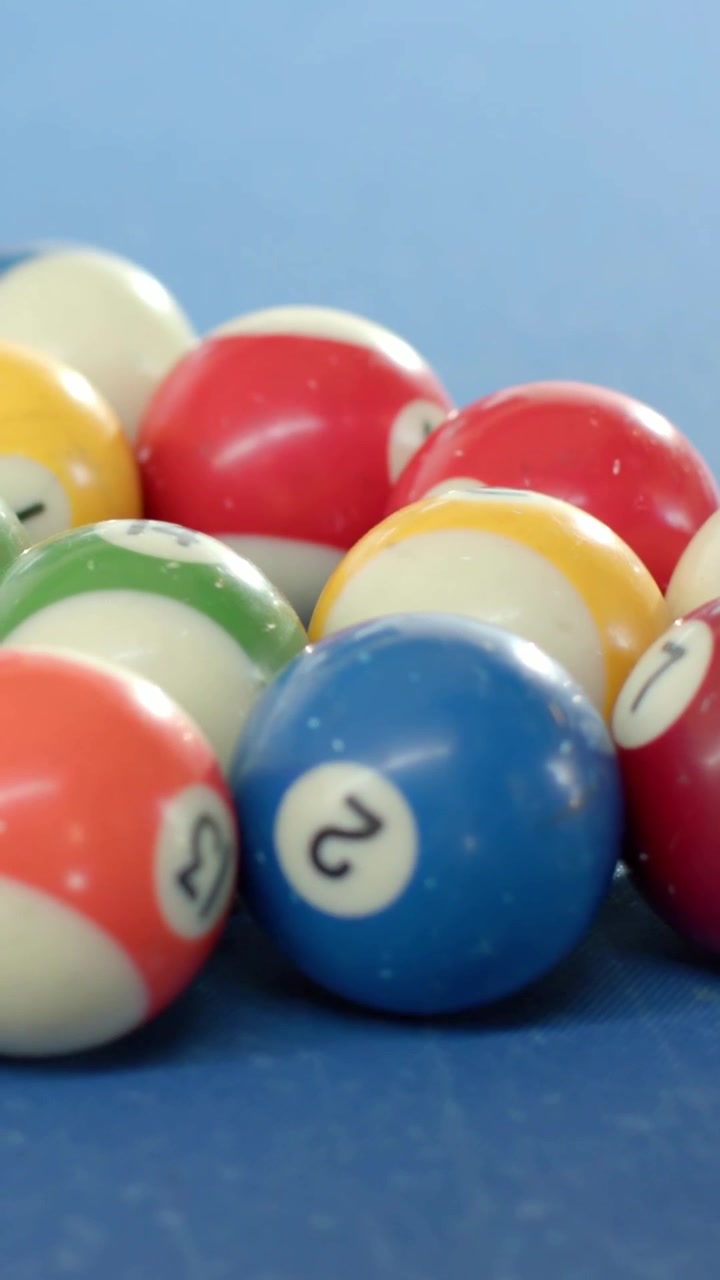 Vertical video: Pulling camera revealing ball cluster shifting focus on blue felt showing blue 2
