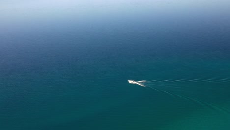 Aerial-View-Of-Speedboat-Cruising-In-The-Calm-Blue-Waters