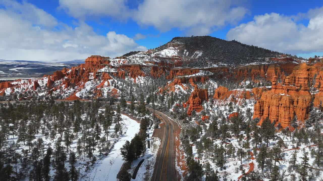 Road Within The Bryce Canyon National Park With Red Canyons, Snow-covered Forest And Hoodoos In Utah, USA. - aerial shot
