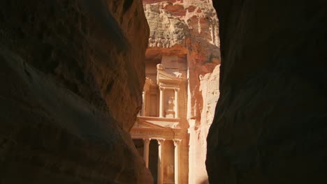 petra temple treasury carved out of rock - popular tourist attraction in jordan