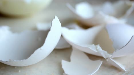 eggshells in a white  bowl on table ,