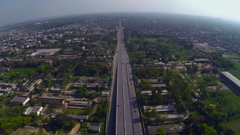 Aerial-over-the-clean-and-green-urban-city`s-highway