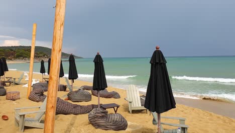 Pan-shot-of-an-abandoned-beach-bar-on-coast-of-Ammolofoi-Beach-Kavala-in-Greece