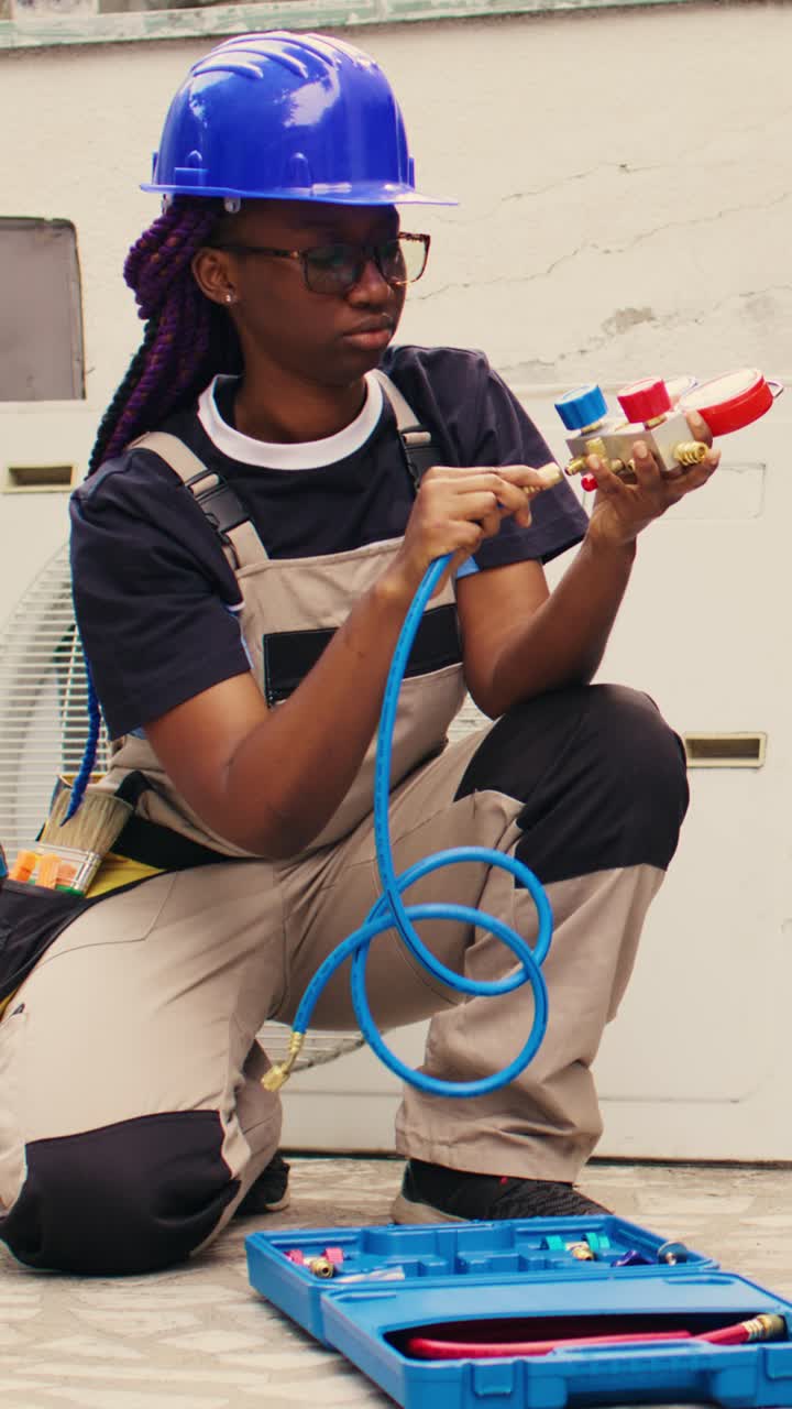 Vertical video Mechanic prepares for condenser checkup