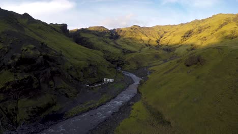 drone shot of valley with seljavallalaug hidden swimming pool in iceland