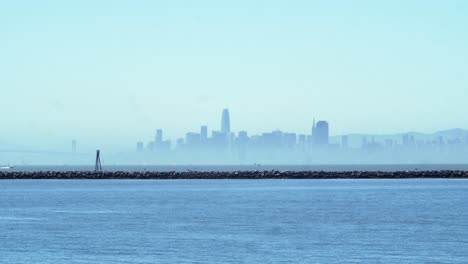 san francisco downtown skyline timelapse with bay bridge and sailboats on sunny day