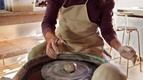 mid section of potter making pot