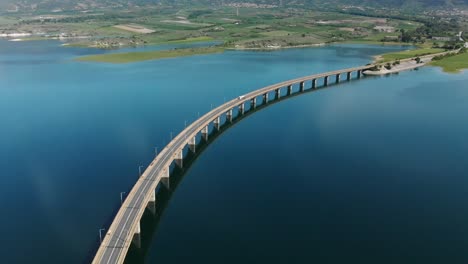 Techniti-Limni-Polifitou--White-truck-driving-on-Polifitou-Lake-Bridge-in-Greece