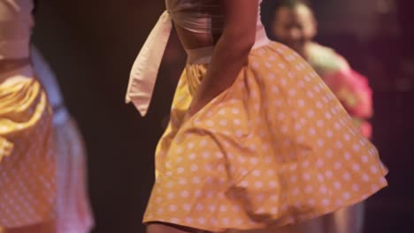 girls-dancers-dancing-joyfully-with-yellow-skirts-at-Cuba,-exotic-dancers-close-up